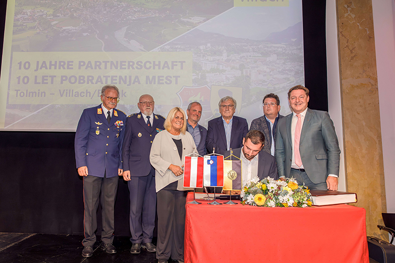 Jubiläumsfeier: Tolmins Bürgermeister Alen Červ unterzeichnet die neue Partnerschaftsurkunde. Hinten: Andreas Stroitz, Jože Dakskobler, Vizebürgermeisterin Gerda Sandriesser, Uroš Brežan, Partnerschaftsinitiator Helmut Manzenreiter, Stadtrat Christian Pober und Bürgermeister Günther Albel. Foto: Olga Bereslavykaya